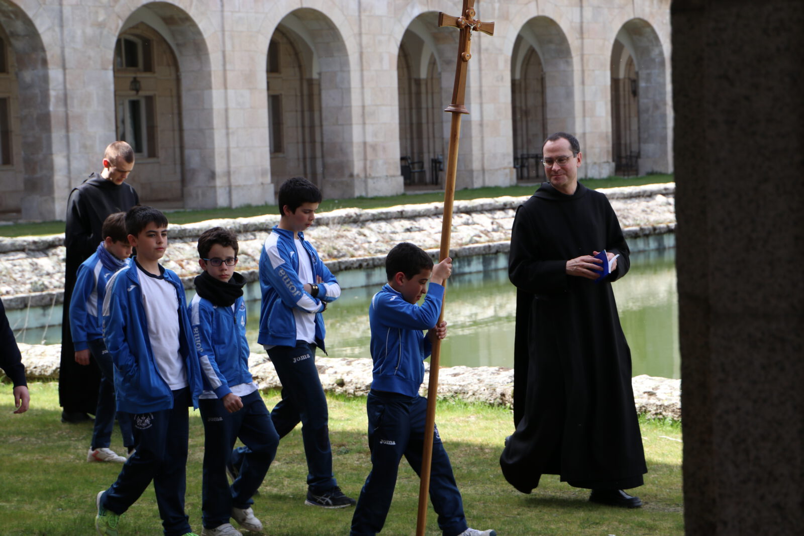 monje y alumnos practicando la espiritualidad benedictina